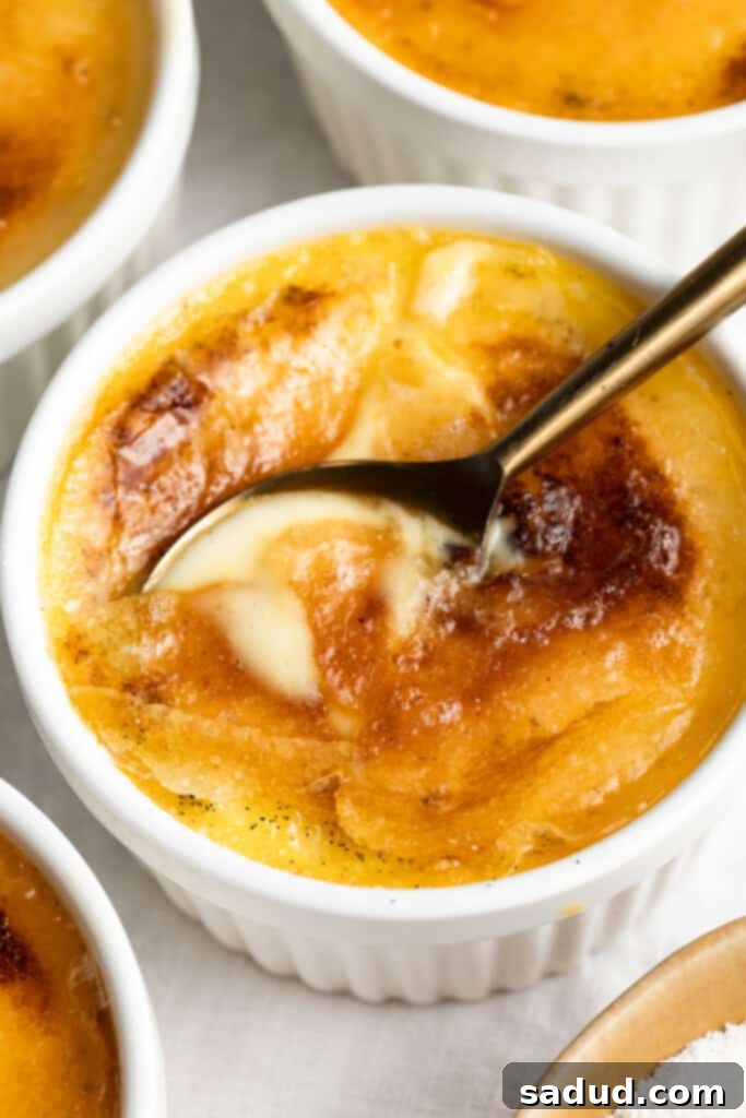 Luscious Keto Creme Brûlée 3 keto creme brulee with a spoon, showing the perfect texture of the low-carb dessert
