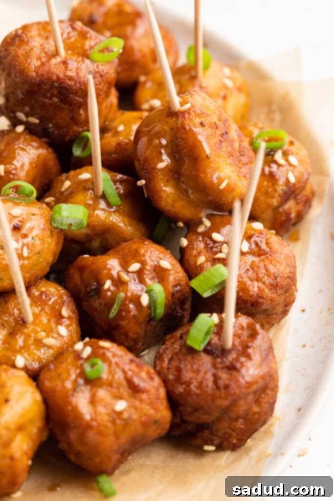 frozen meatballs in air fryer on a plate with toothpicks