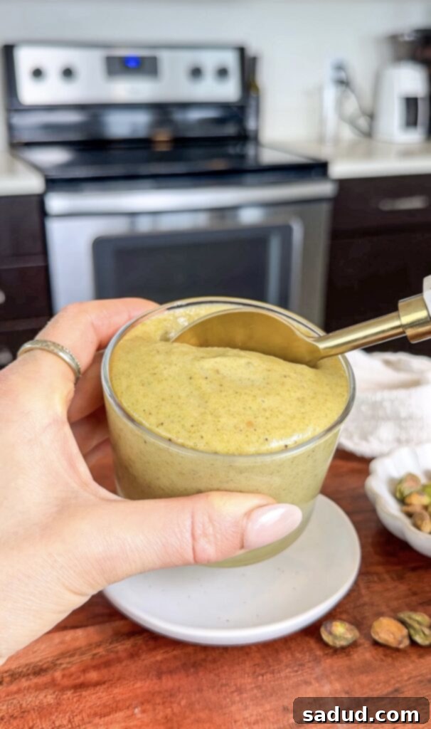 Vegan, paleo, homemade pistachio cream in a jar, highlighting its healthy attributes.