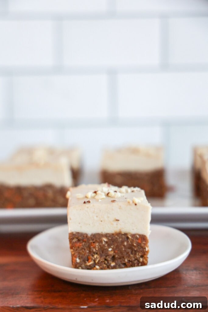 Healthy, vegan, high protein no-bake carrot cake slice with cashew cream cheese frosting.
