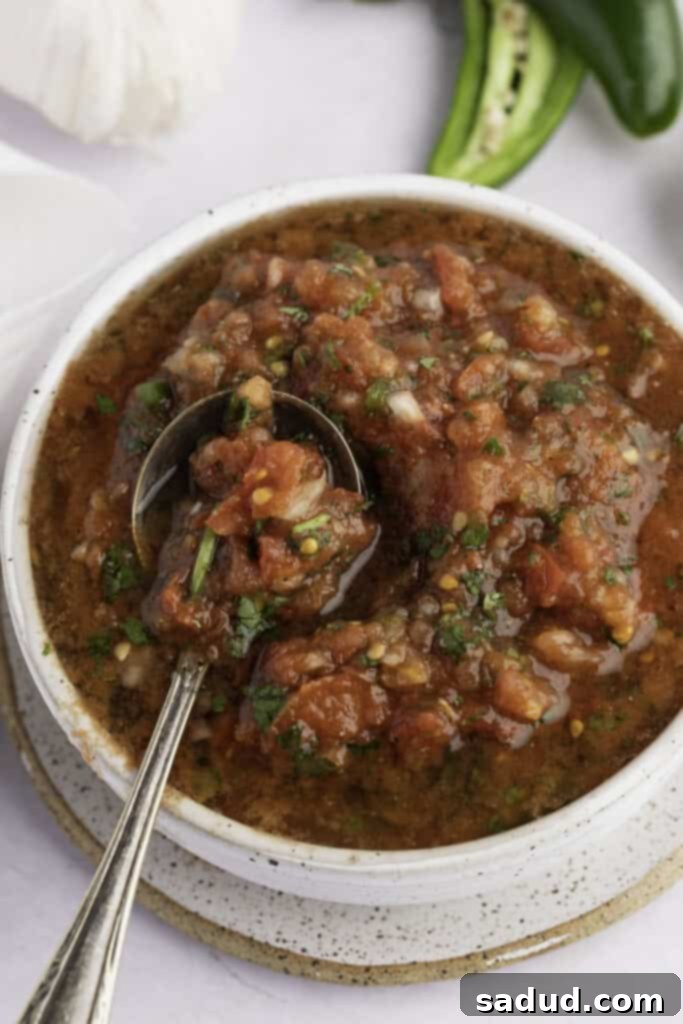 Overhead view of keto salsa in a white bowl, garnished with fresh cilantro
