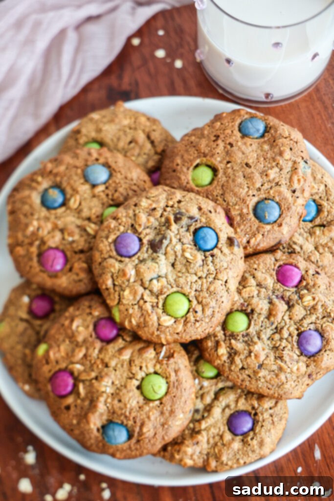 A stack of delicious gluten-free monster cookies on a plate, showing the chocolate chips and colorful candies.