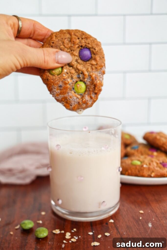 Dunking a perfectly baked gluten-free monster cookie into a glass of milk.