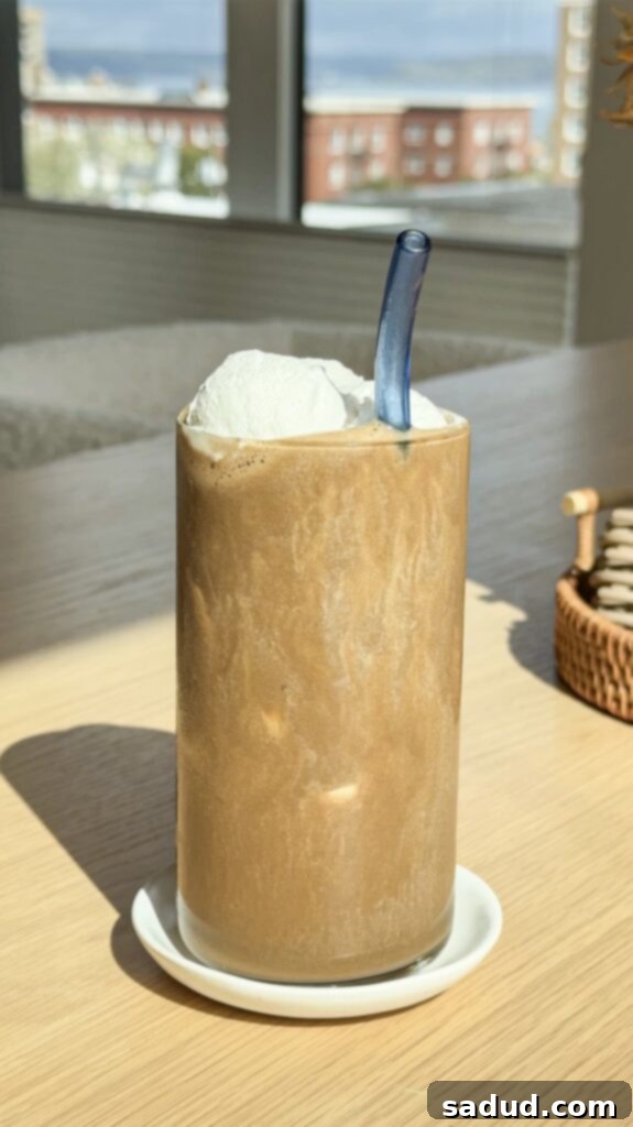 Frosted Banana Buzz 3 close-up of banana coffee smoothie in a glass with a straw