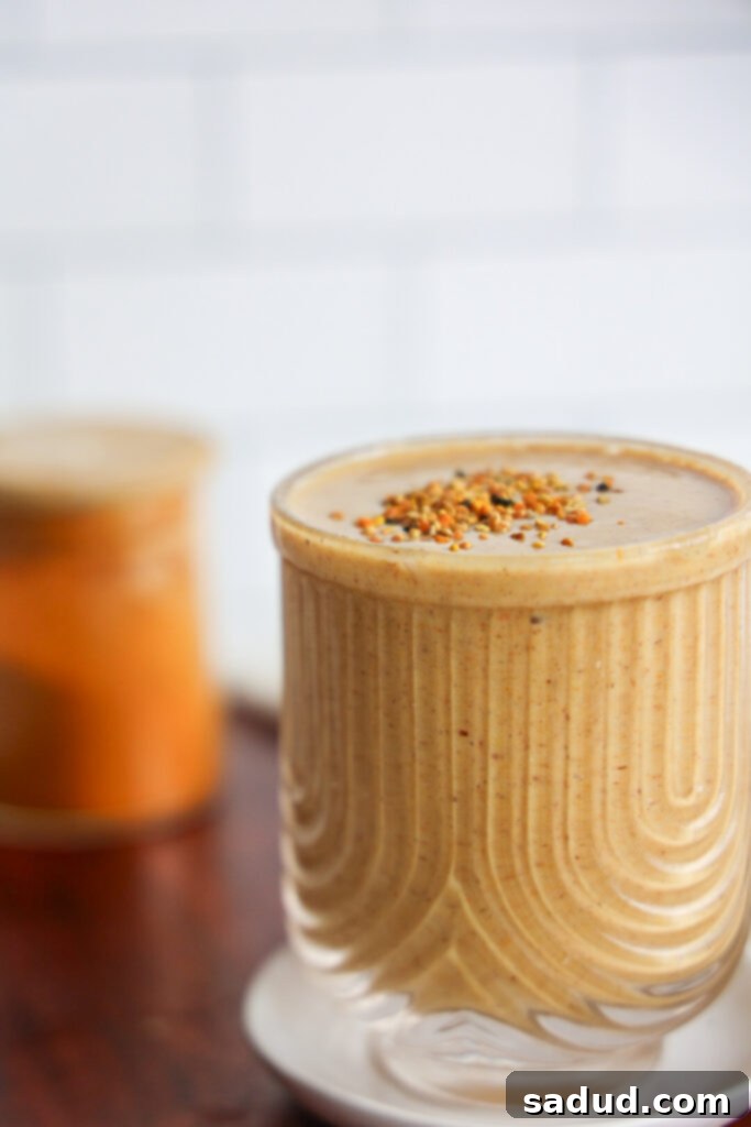 Pouring Turmeric Golden Milk Smoothie into a glass