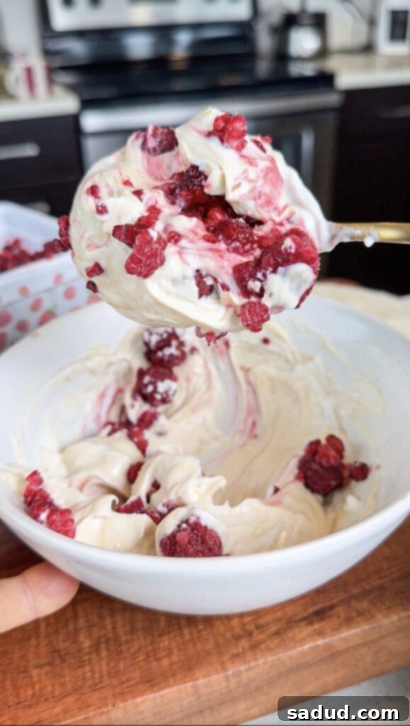 A close-up of a single raspberry matcha frozen yogurt bite.