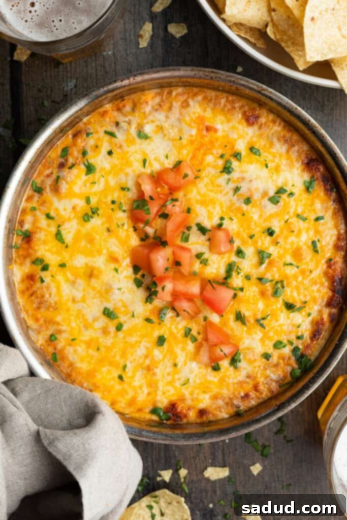 overhead image of chili cheese dip in a skillet with chips on the side