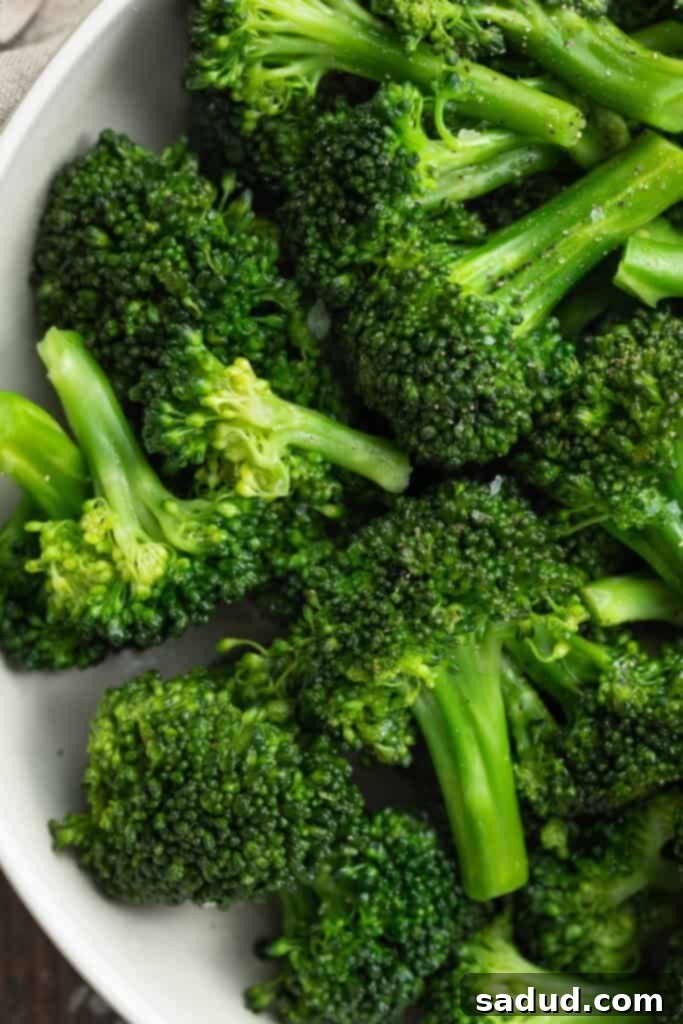 Silky Sous Vide Broccoli Florets 3 Close-up view of vibrant green sous vide broccoli in a white bowl, ready to be served.