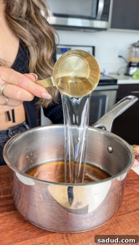 Whipping the marshmallow mixture in a stand mixer.