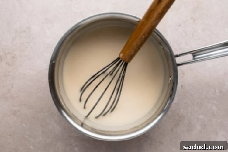 Sugar, cornstarch, and coconut milk in medium saucepan with wooden-handled whisk.