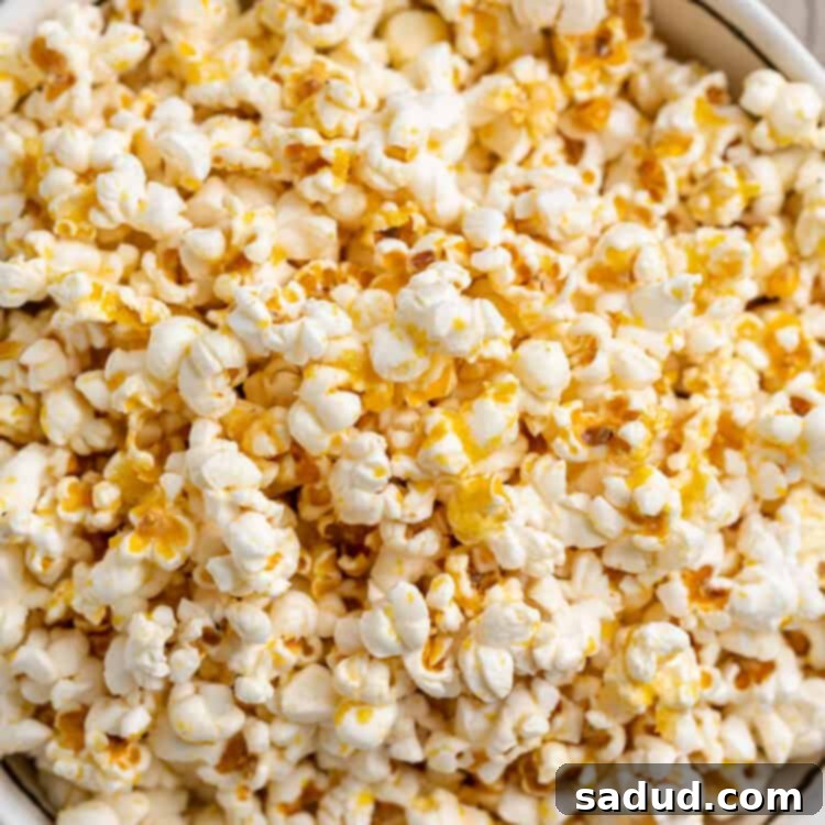 Overhead, close-up view of a large bowl of vegan buttery popcorn.