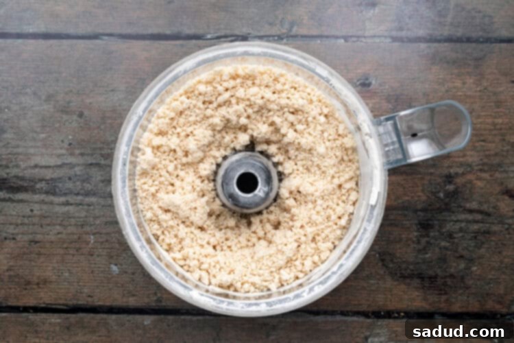 Irresistible Vegan Empanadas 6 Overhead view of a food processor bowl of empanada dough ingredients.