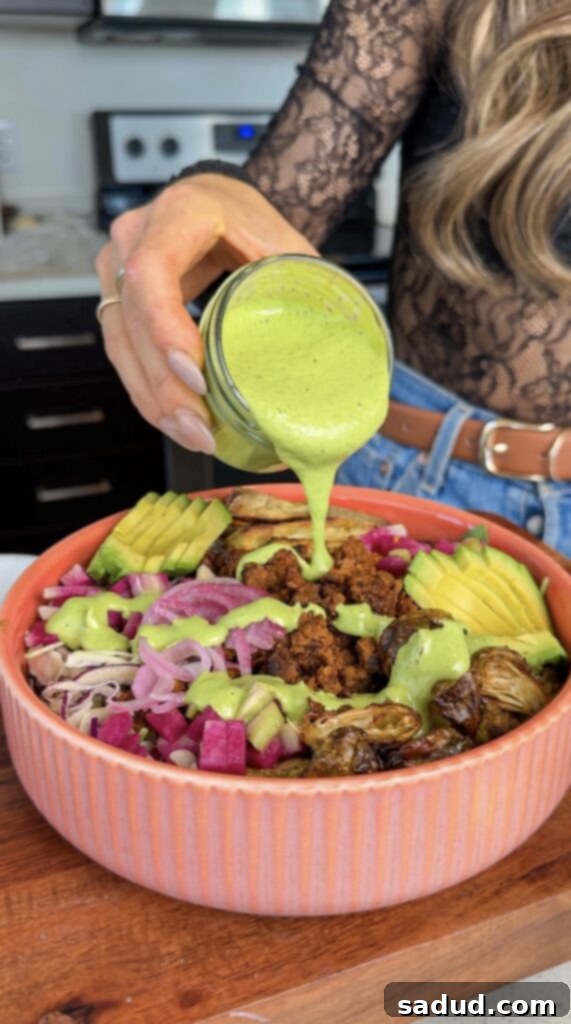 Vegan grain bowl with green herby tahini sauce.