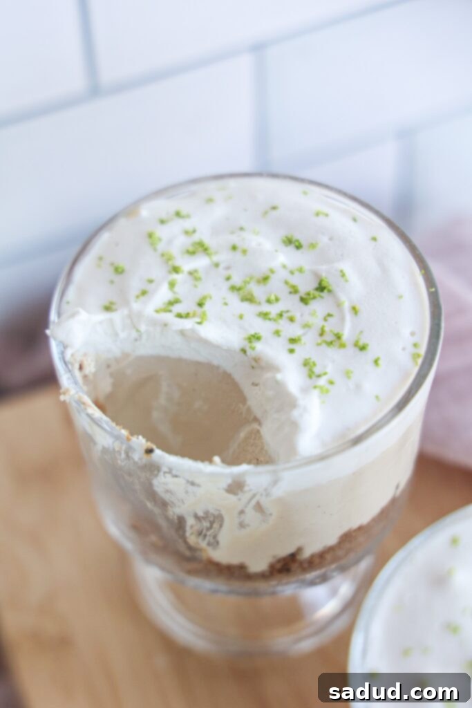 Easy no-bake, vegan key lime pie in a jar, topped with coconut cream and lime zest.