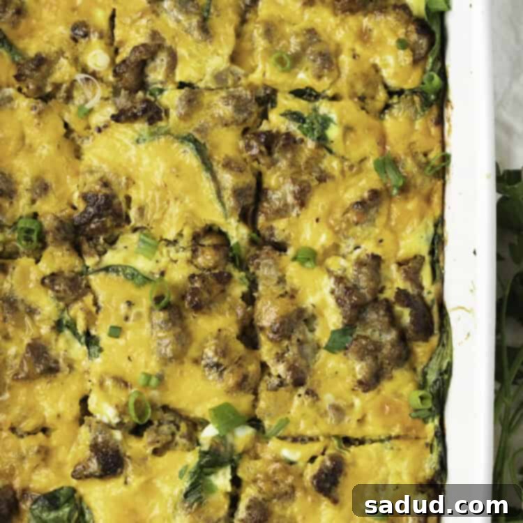 Overhead view of keto breakfast casserole in a white casserole dish, with the casserole cut into squares.