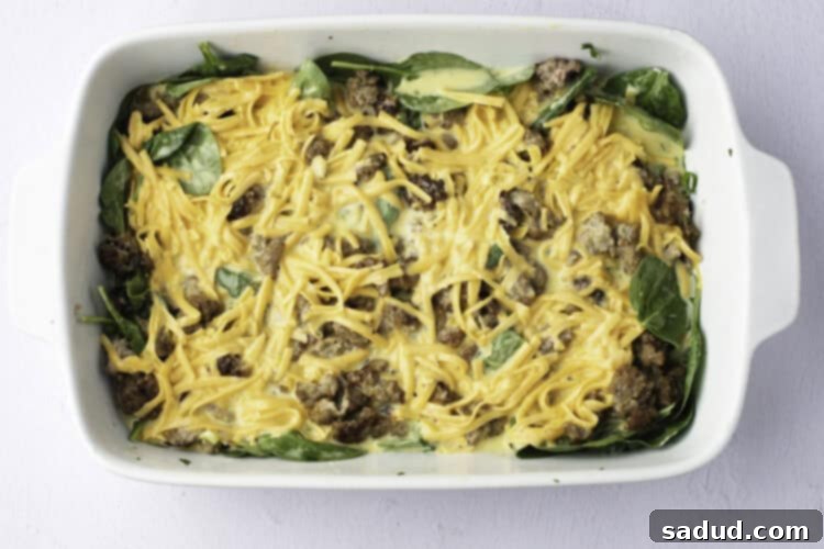 Overhead view of an unbaked keto breakfast casserole in a casserole dish.
