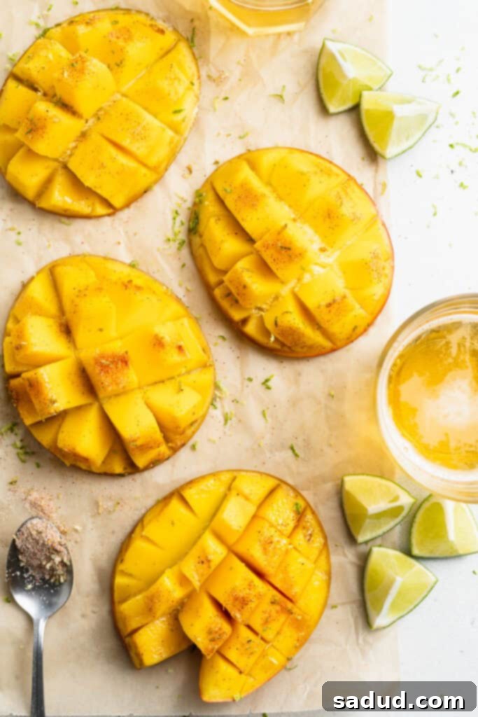 Overhead view of sliced, grilled mango on a sheet of parchment paper on a white counter.