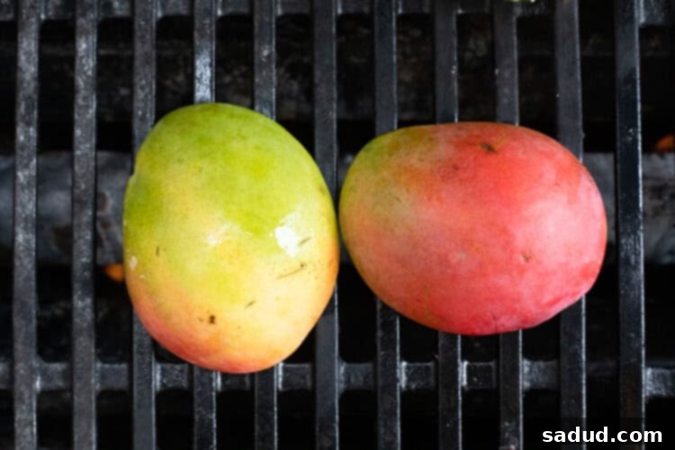 Mangoes cut-side down on grill.