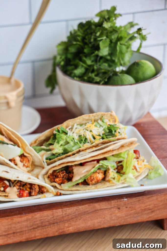 Delicious healthier homemade Cheesy Gordita Crunch stacked on a wooden board with fresh ingredients