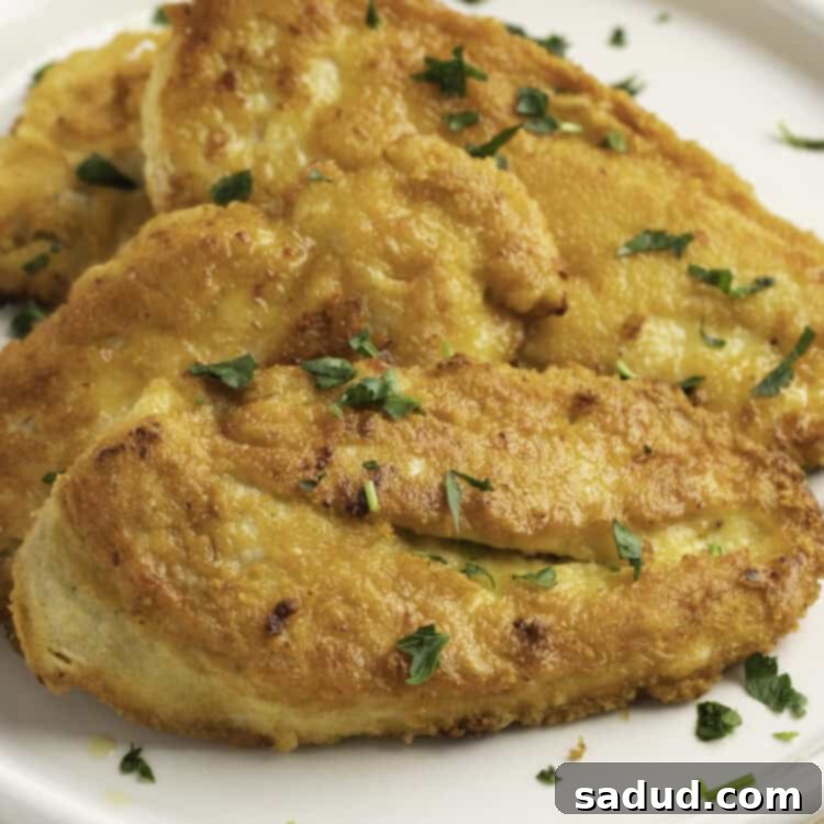 Close-up view of Crusted Chicken Romano on a plate, showing the golden brown crispy texture of the breading.