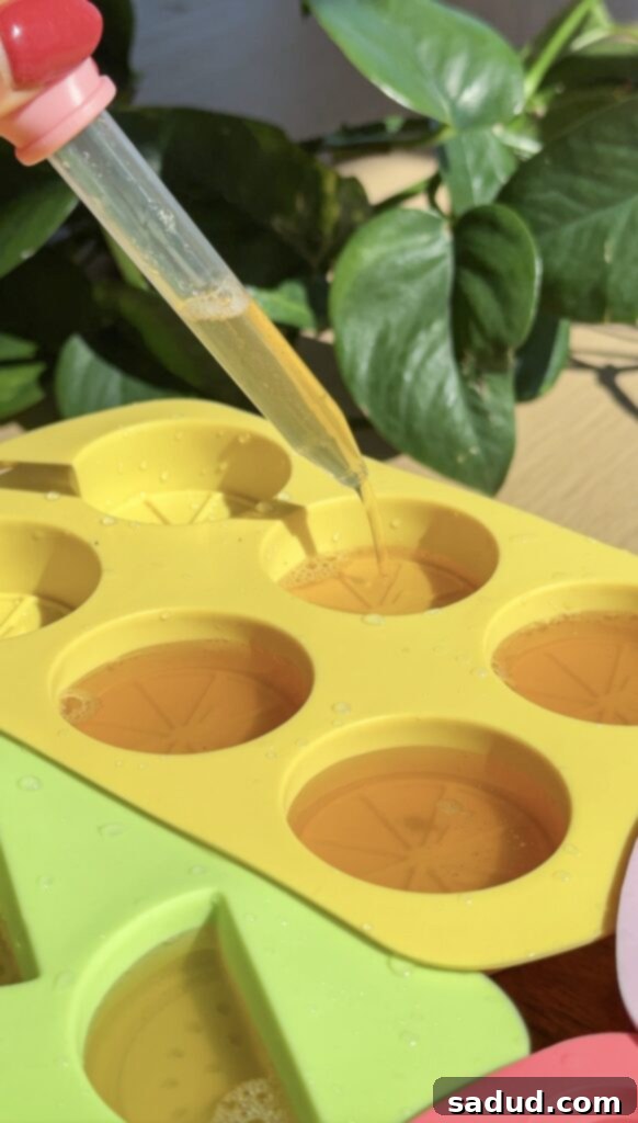 Pouring homemade fruit gummy mixture into molds