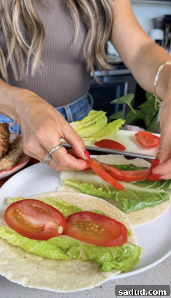 Crispy chicken snack wrap with vibrant fillings on a wooden board.