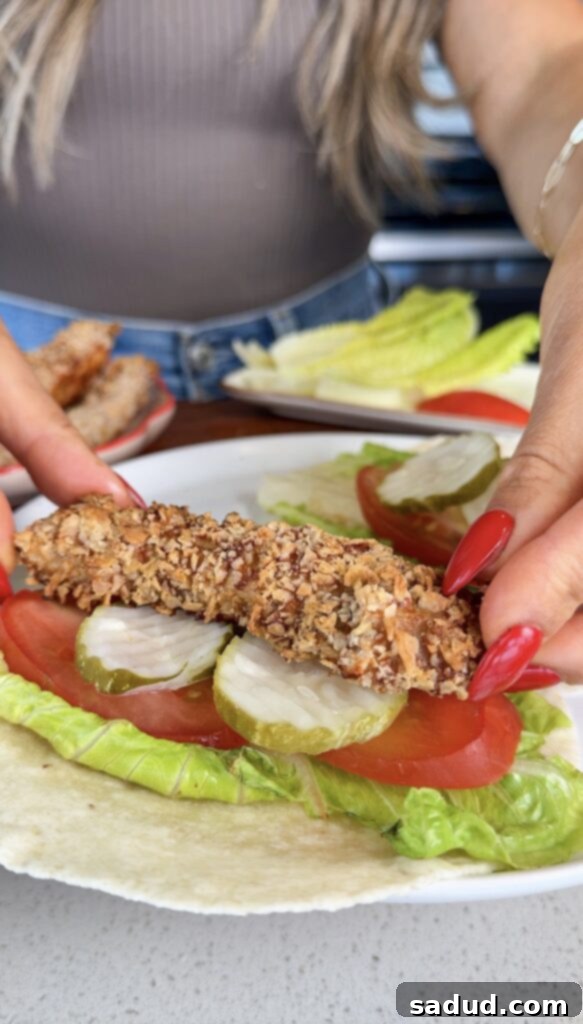 Close-up of a perfectly rolled crispy chicken snack wrap.