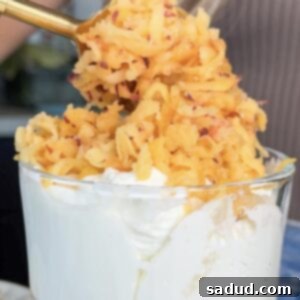 Healthy Frozen Peach Crisp with shaved peaches over yogurt and a crispy oat topping.