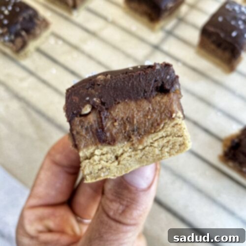 Close-up of a Sunbutter Caramel Bar showing its distinct layers and appealing texture.