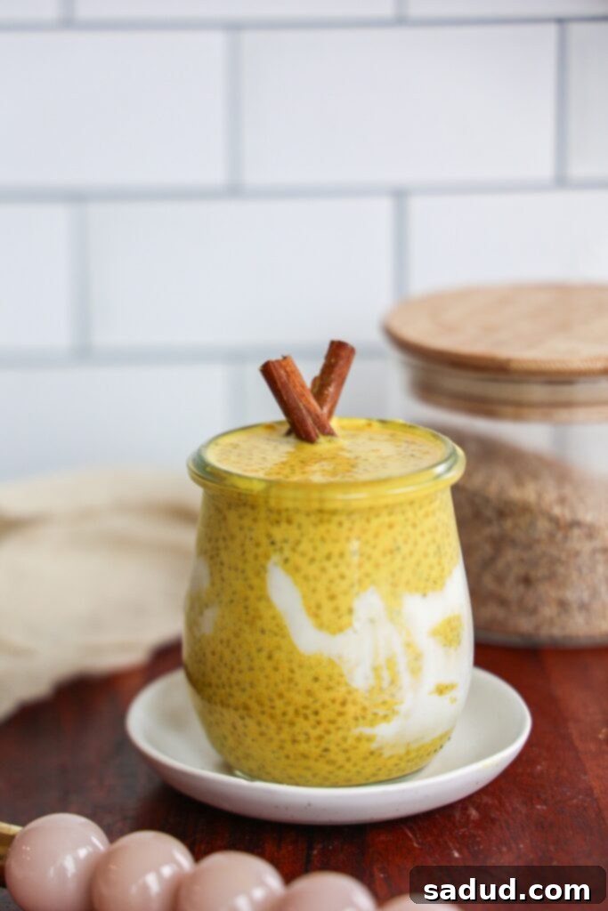 A bowl of golden milk chia pudding topped with fresh fruit and shredded coconut, emphasizing its healthy and delicious appeal.