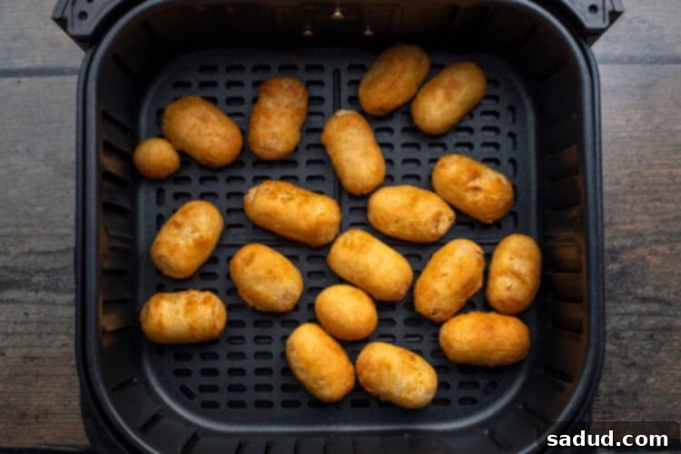 Finished plate of mini corn dogs with dipping sauce