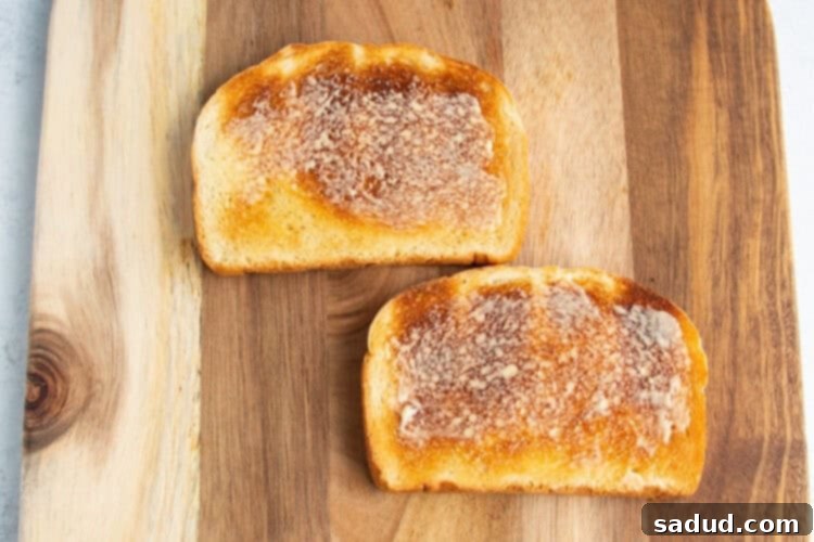 Buttered toast on a cutting board.