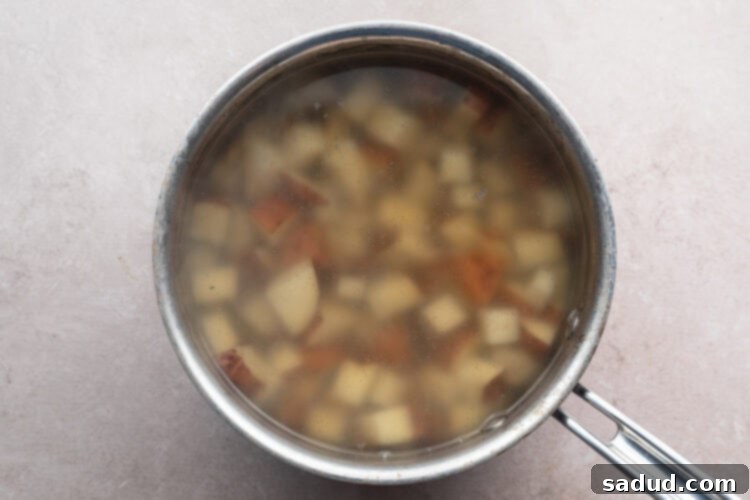 Overhead view of cubed red skin potatoes in a pot of boiling water.