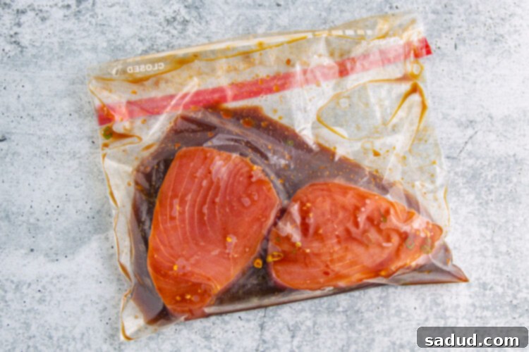 Ahi tuna steaks marinating in a ziploc bag with a delicious ginger-soy mixture.