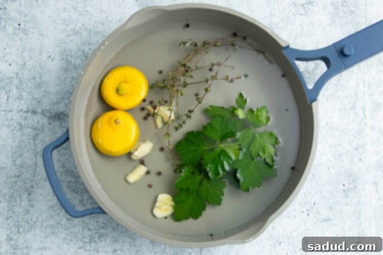 Aromatics for poached shrimp in a large pot.