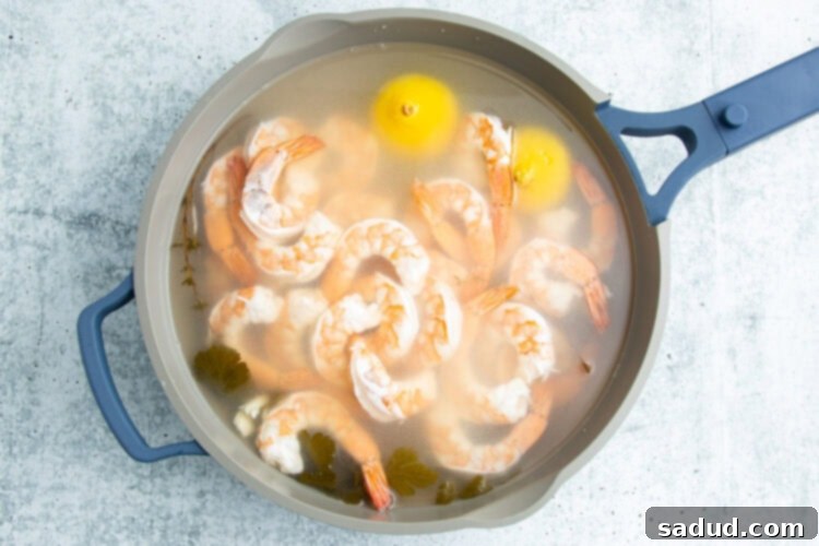 Poached shrimp in a large pot.