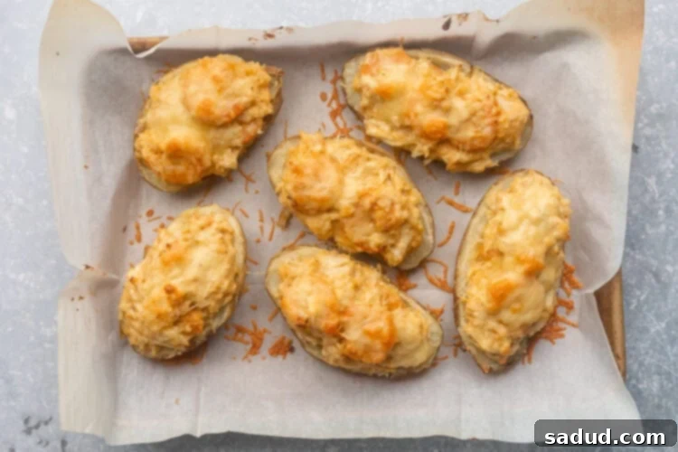 Finished seafood-stuffed twice baked potatoes on a baking sheet, ready to serve.