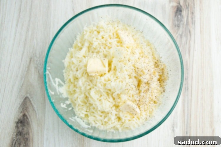 Freshly mashed potatoes in a clear glass bowl, showcasing their smooth texture.