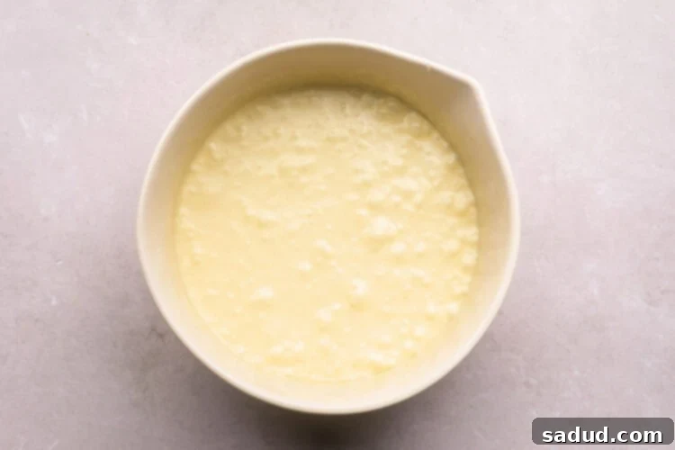 Matcha Magic White Chocolate Brownies 6 Wet ingredients for matcha brownies in a large mixing bowl.