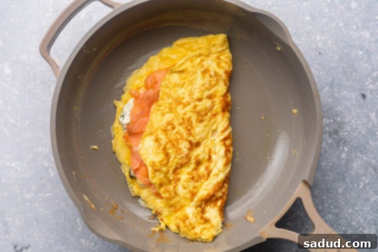Folded salmon omelette in a large skillet.