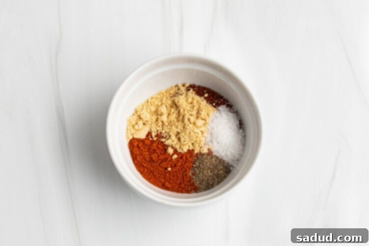 Dry rub spice blend ingredients in medium white bowl.