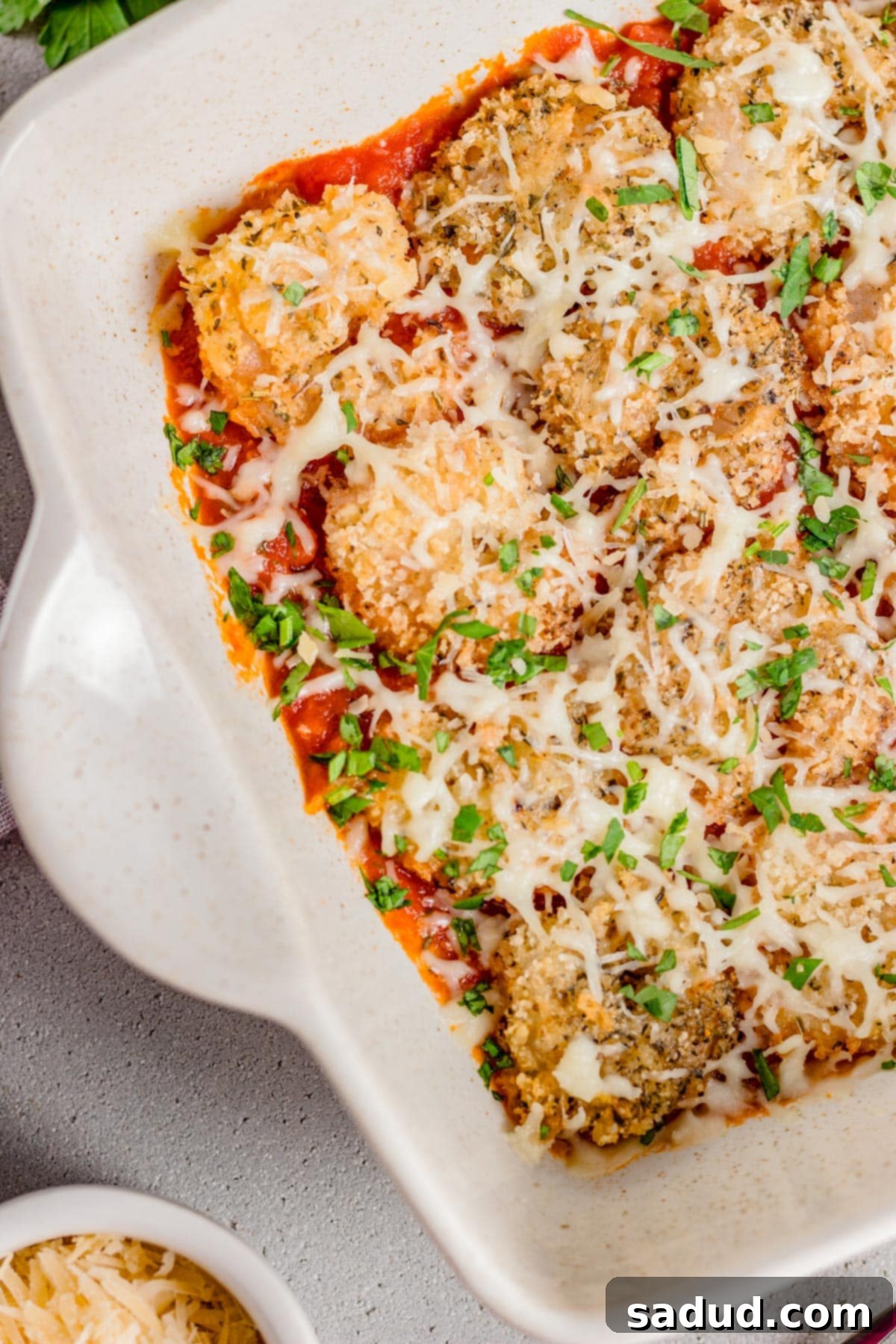 Irresistible Shrimp Parmesan 2 Top down view of a casserole dish of shrimp parmesan.