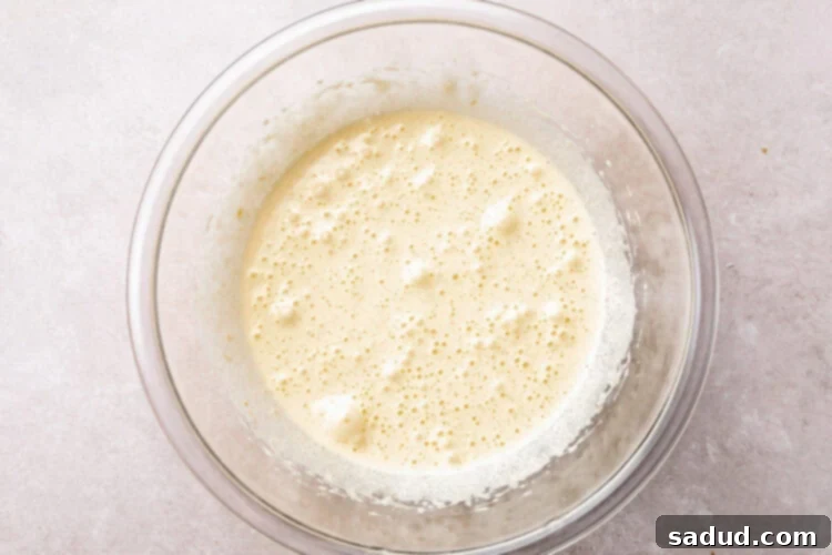 Sugar and eggs beaten together in large glass mixing bowl.