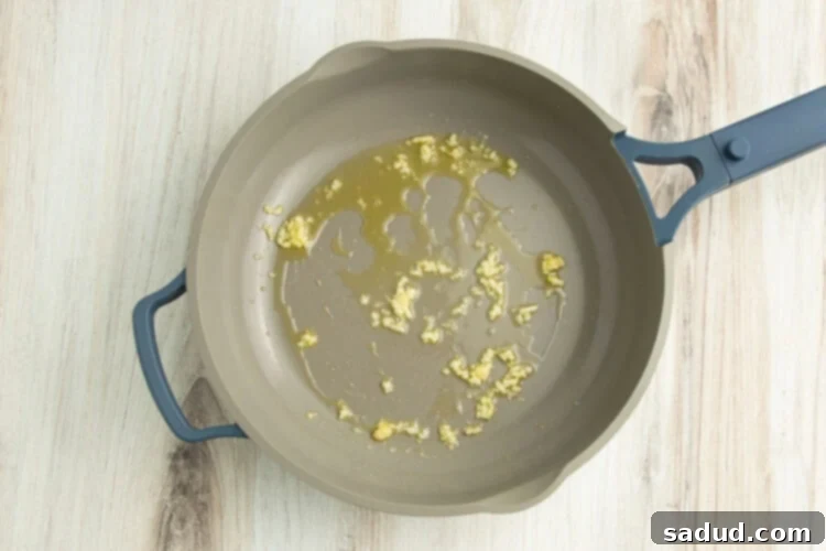 Oil and minced garlic in a large skillet.