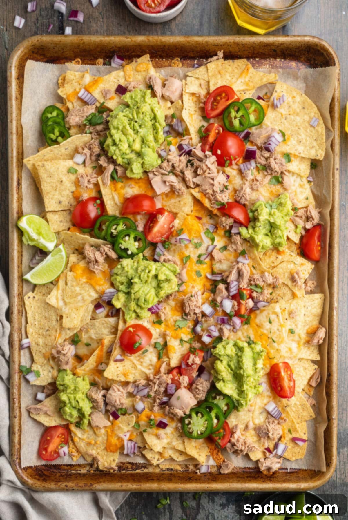 Effortless Tuna Nacho Feast 3 Overhead view of a large sheet pan covered with tuna nachos.