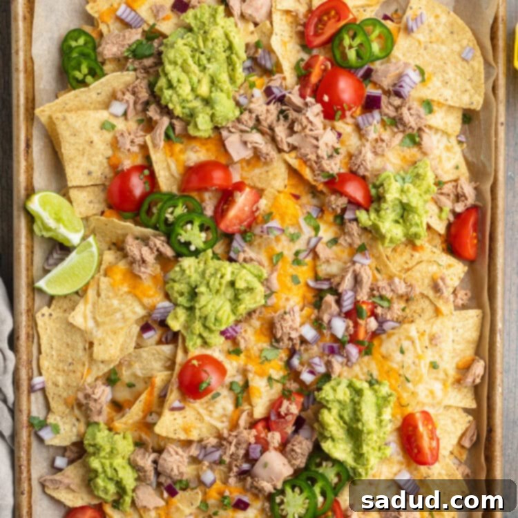 Effortless Tuna Nacho Feast 4 Overhead view of a large sheet pan covered with tuna nachos.