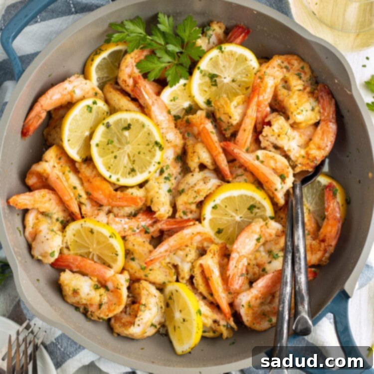Overhead view of shrimp francese in a large skillet.