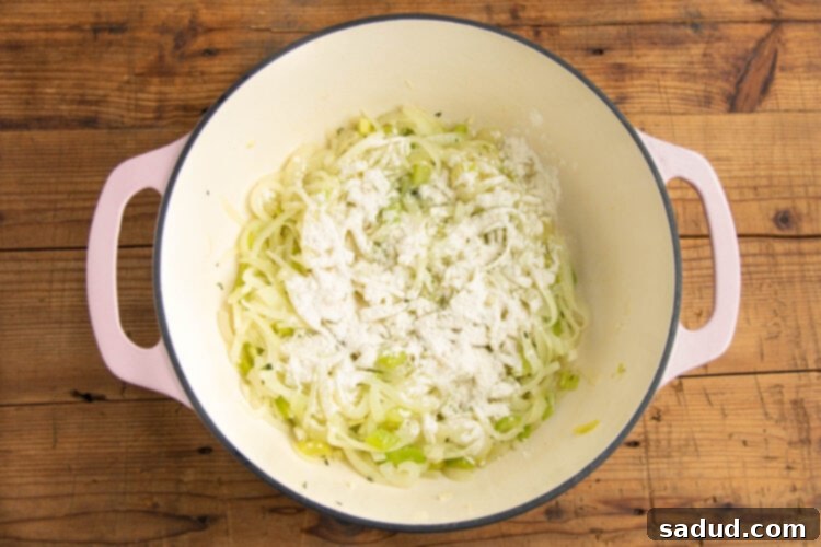 Onions and celery in a large pot with minced garlic and thyme.