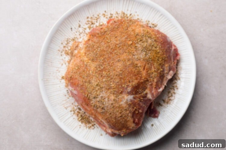 2 pound pork shoulder coated in spice rub.