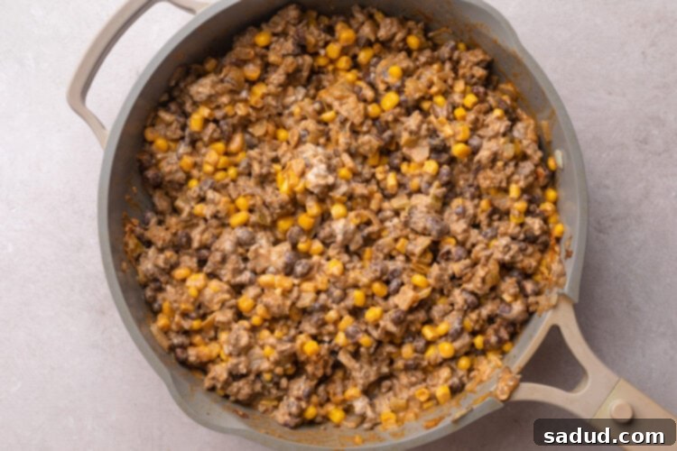 Walking taco casserole filling in a large skillet.